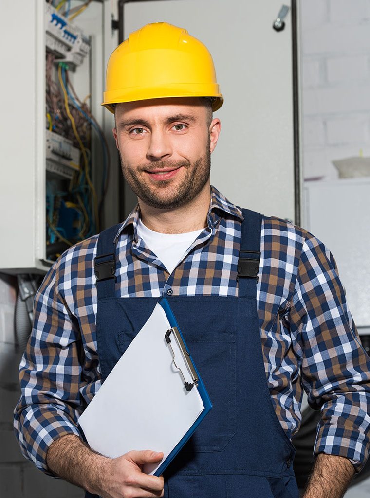 electrician-holding-clipboard-and-smiling-by-elect-JZP244K.jpg